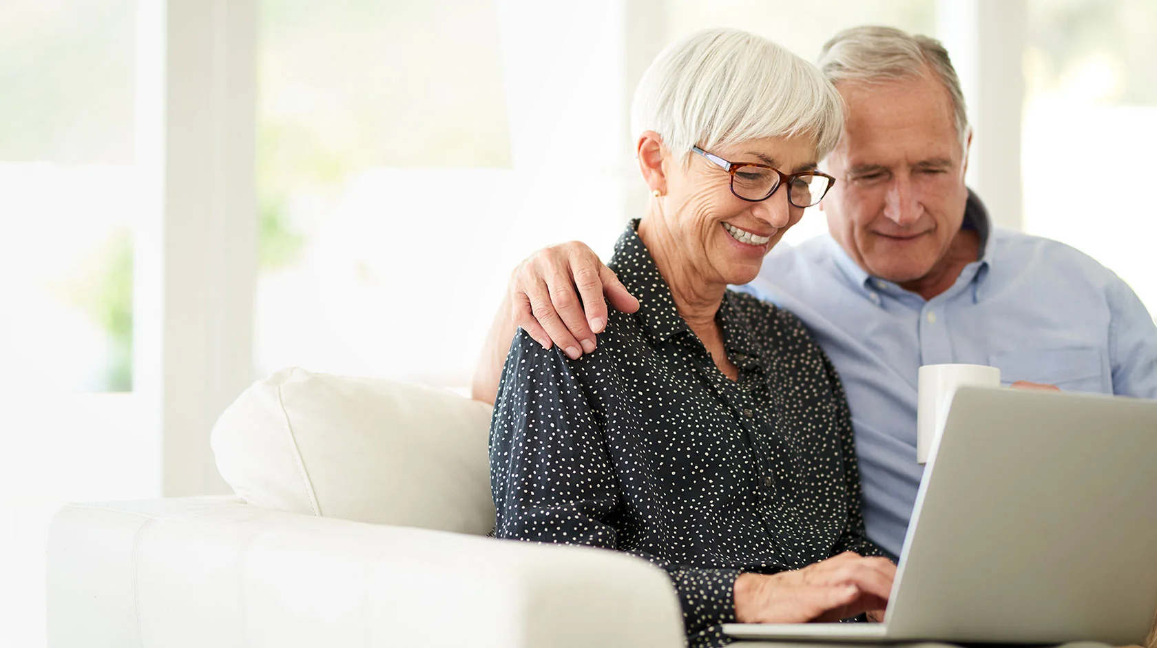 Older couple looking through information on a laptop together